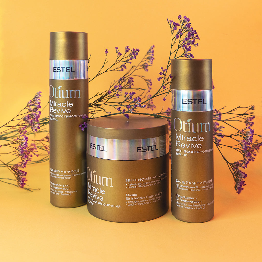 ESTEL Otium Miracle Revive Pflegeset mit Shampoo, Maske und Balsam vor dekorativen violetten Blüten vor gelbem Hintergrund